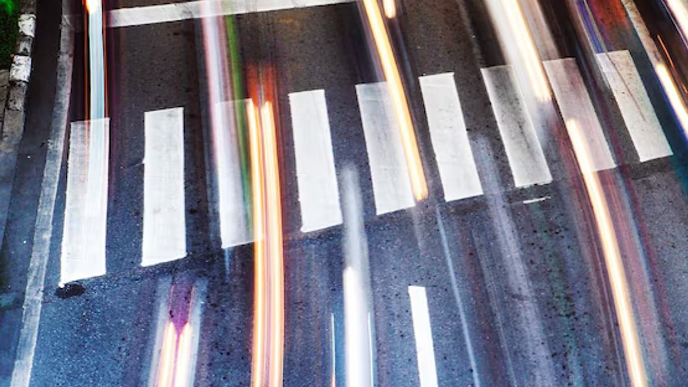 Motion-blurred city road lanes with light trails